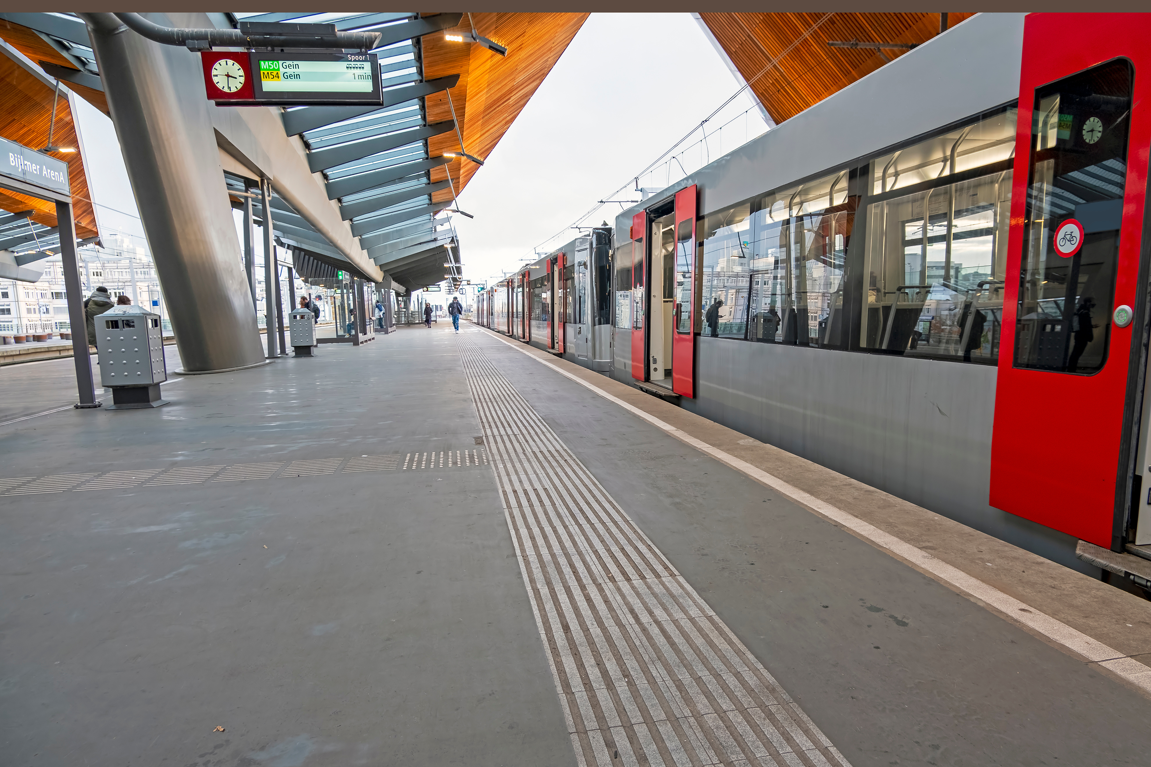 Metro departing from Bijlmer Station platform in Amsterdam, Netherlands.