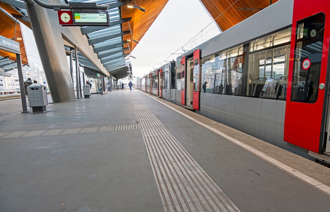 Metro departing from Bijlmer Station platform in Amsterdam, Netherlands.