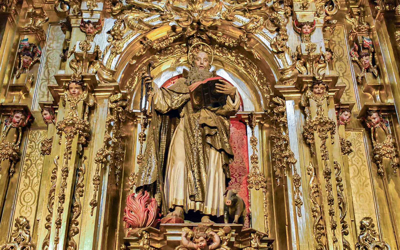 Gold-leaf altarpiece with Saint James carving in Segovia's Gothic cathedral, Spain.