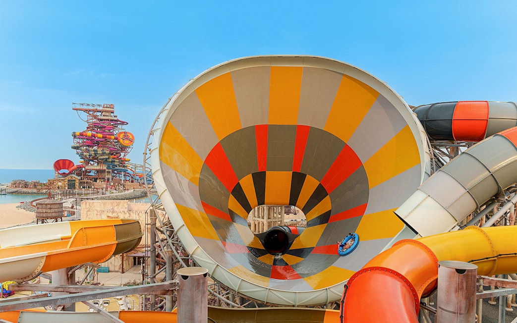 Visitors on a colorful water slide at Meryal Waterpark.
