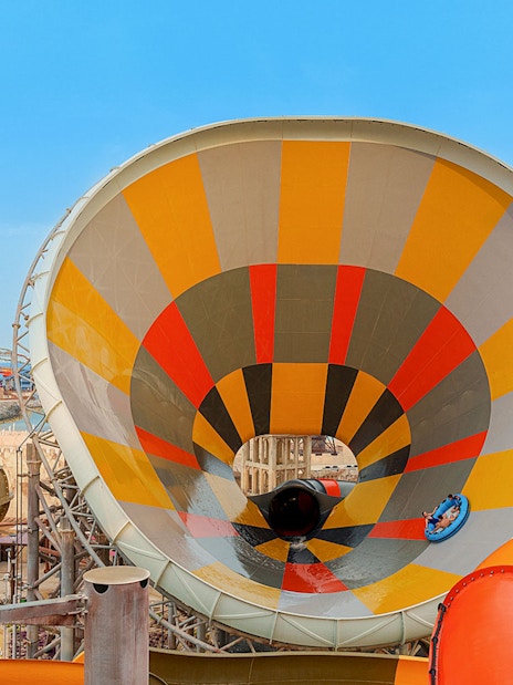 Visitors on a colorful water slide at Meryal Waterpark.