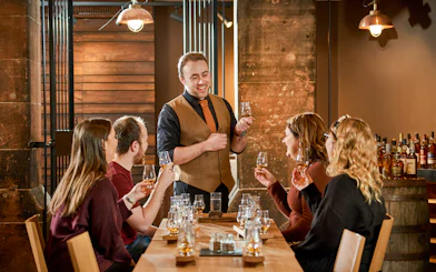 Group enjoying whisky tasting session at Scotch Whisky Experience.