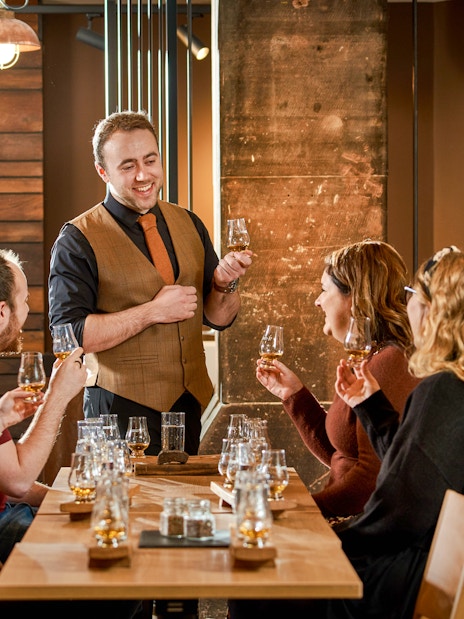 Group enjoying whisky tasting session at Scotch Whisky Experience.
