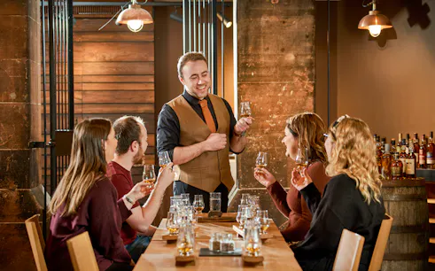 Group enjoying whisky tasting session at Scotch Whisky Experience.