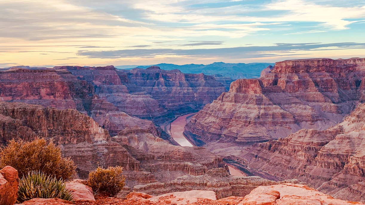 Grand Canyon scenic view with layered rock formations and Colorado River, Las Vegas tour experience.