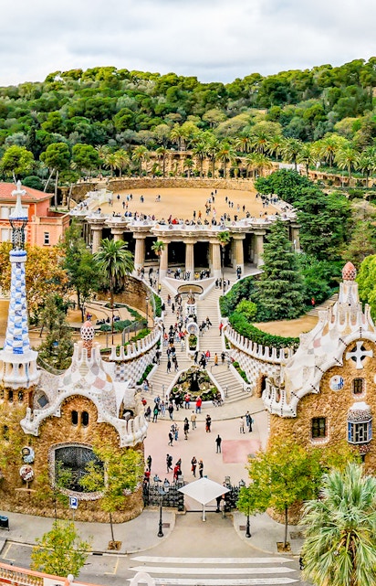 Park Güell entrance with colorful mosaic buildings in Barcelona, Spain.