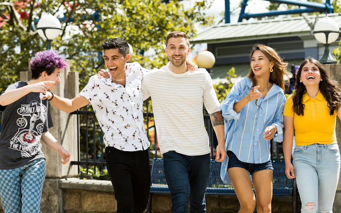 Friends walking towards rides at Six Flags New England, Boston.