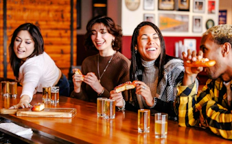 Visitors enjoying pretzels and drinks at a Seattle Center food tour.