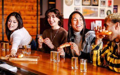 Visitors enjoying pretzels and drinks at a Seattle Center food tour.