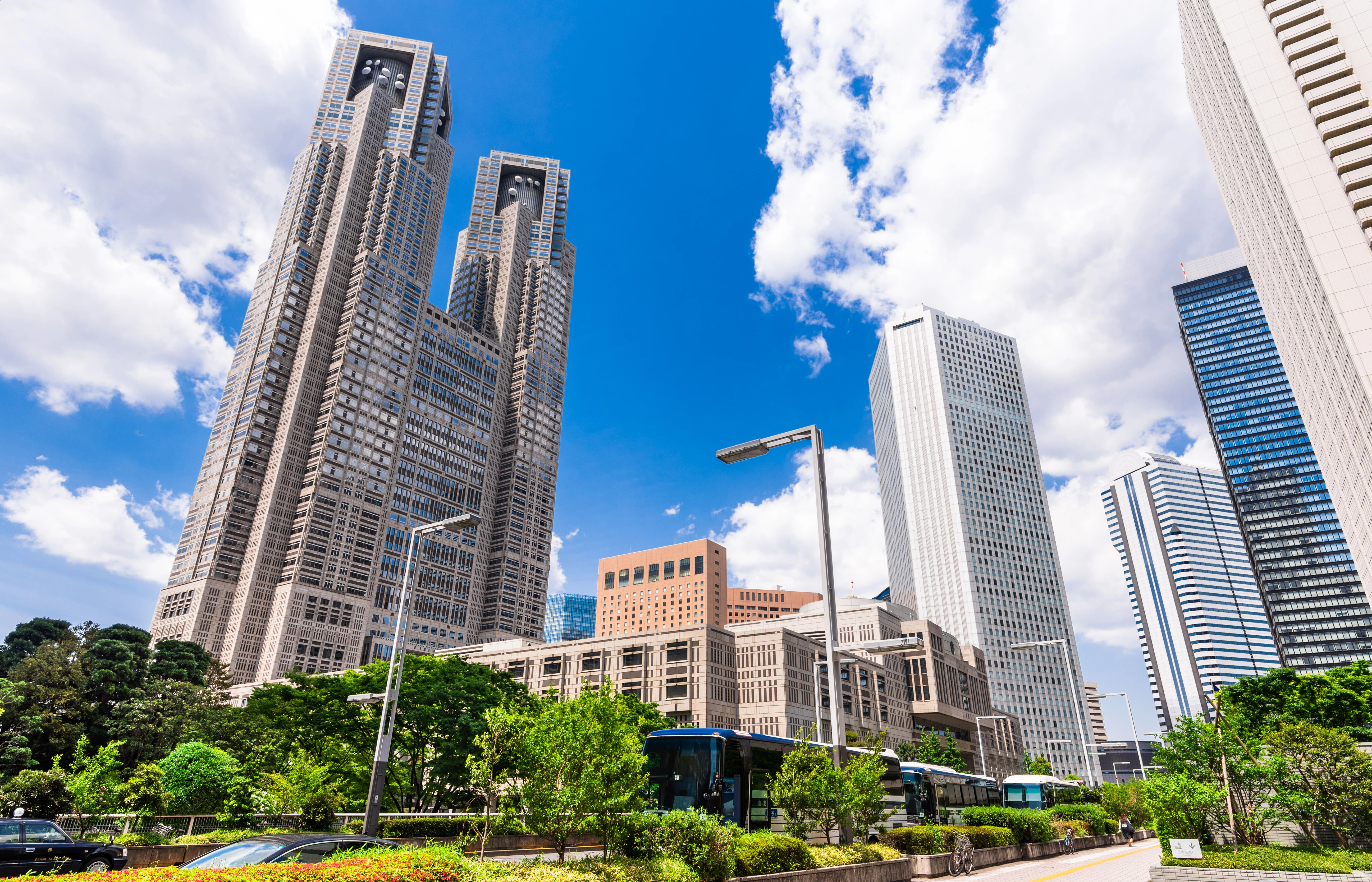 Tokyo Metropolitan Government Building with surrounding skyscrapers and greenery.