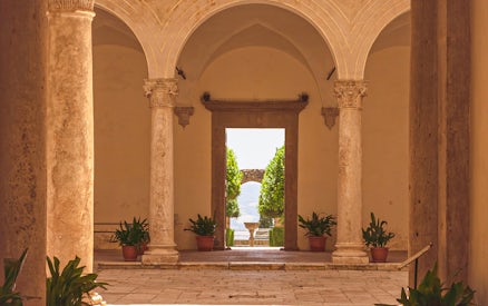 Courtyard view with stone columns at Palazzo Piccolomini, Italy.