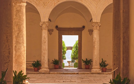 Courtyard view with stone columns at Palazzo Piccolomini, Italy.