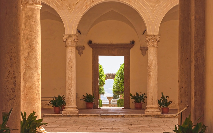 Courtyard view with stone columns at Palazzo Piccolomini, Italy.