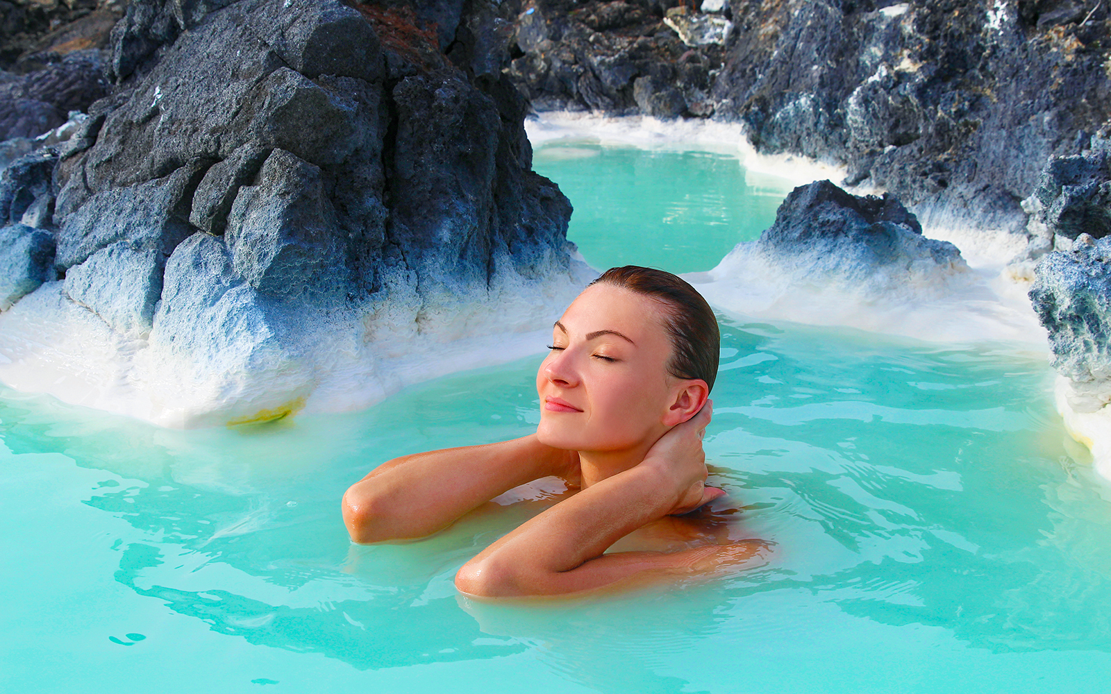Blue Lagoon geothermal spa in Iceland with visitors enjoying the warm, mineral-rich waters.