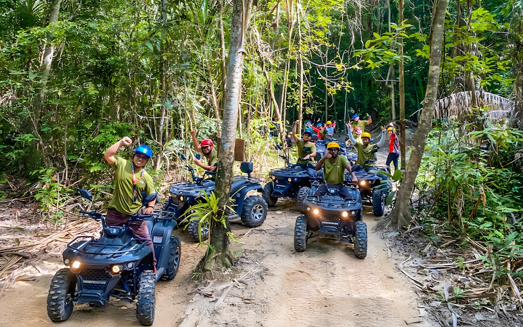 ATV riders on a forest trail during Langkawi Sky ATV Ride at Mountain Manchinchang.