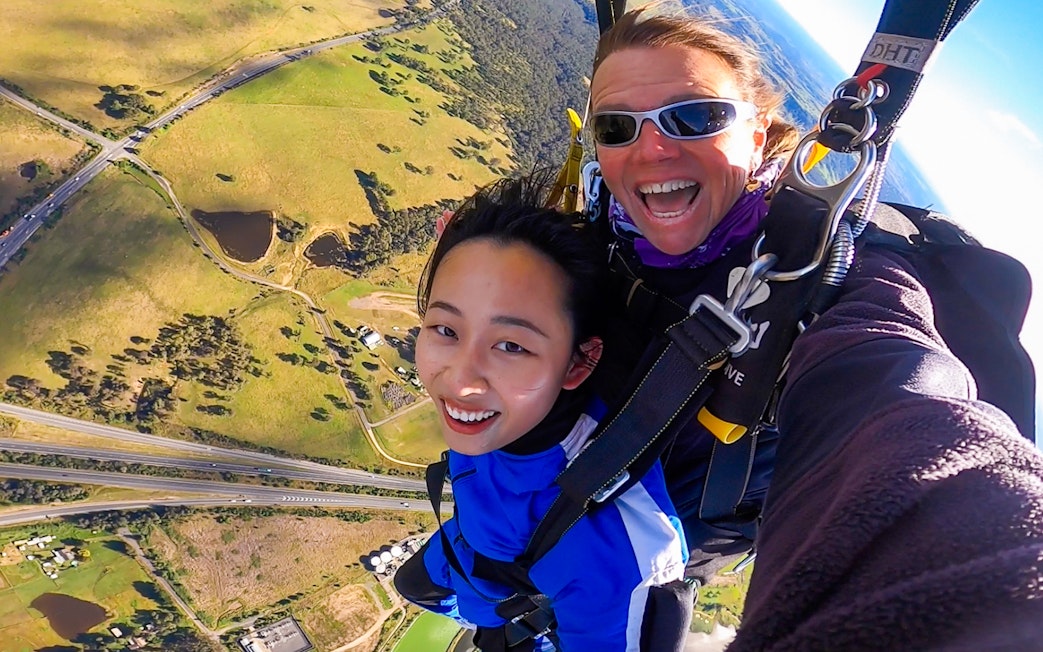Tandem skydive over Sydney with city views and landscape below.