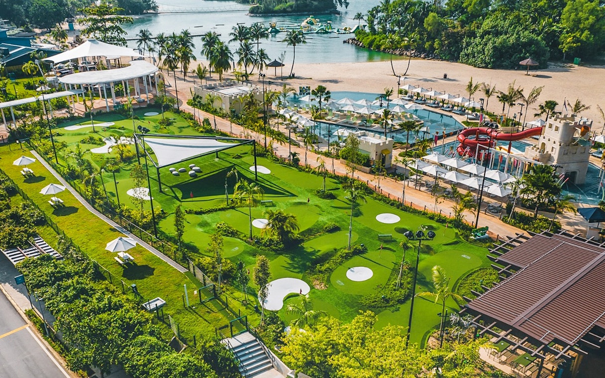 Mini-golf course with water park and beach in the background, UltraGolf General Ticket.