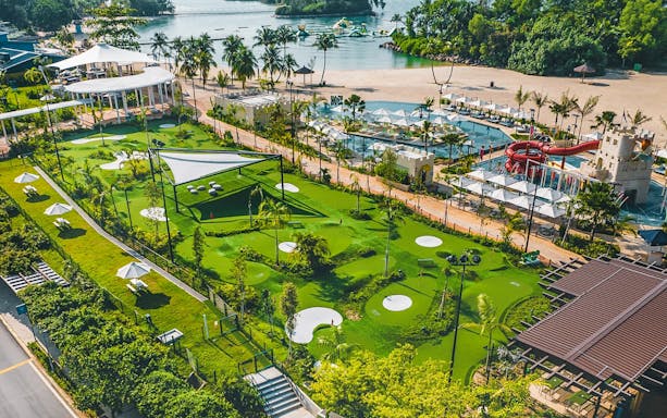 Mini-golf course with water park and beach in the background, UltraGolf General Ticket.