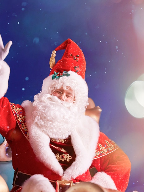 Santa Claus waving during Disneyland Paris Christmas event.
