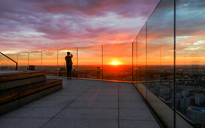 Observation deck at Highline Warsaw with sunset view over the city.