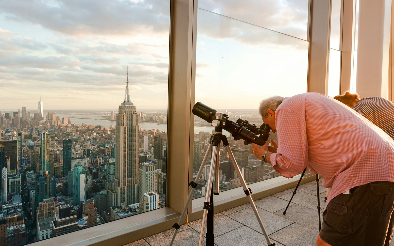 Visitors stargazing through telescopes at Summit One Vanderbilt, New York, during Astronomy Nights event.