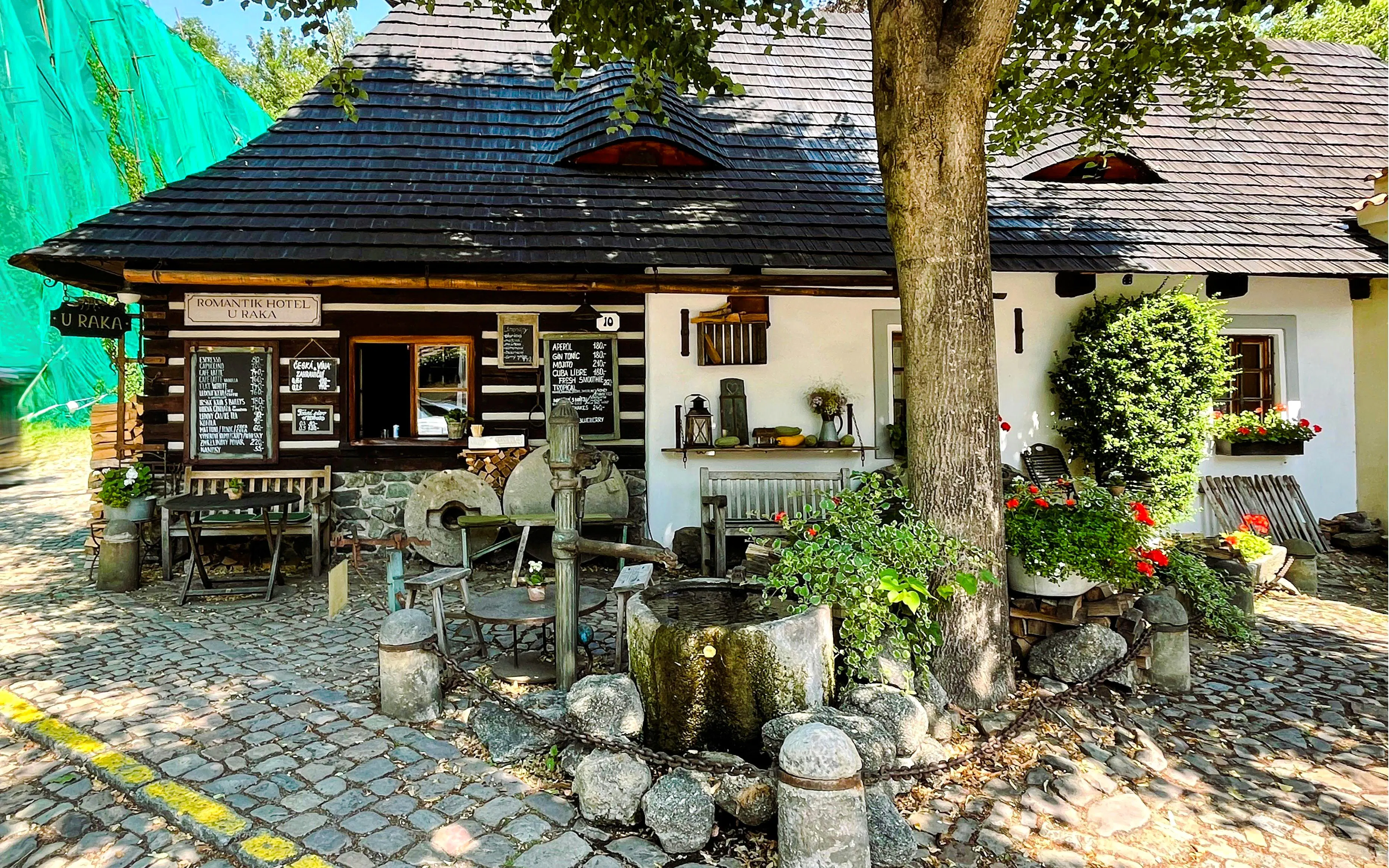 Romantik Hotel U Raka's rustic exterior with cobblestone path in Nový Svět, Prague.