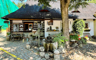 Romantik Hotel U Raka's rustic exterior with cobblestone path in Nový Svět, Prague.