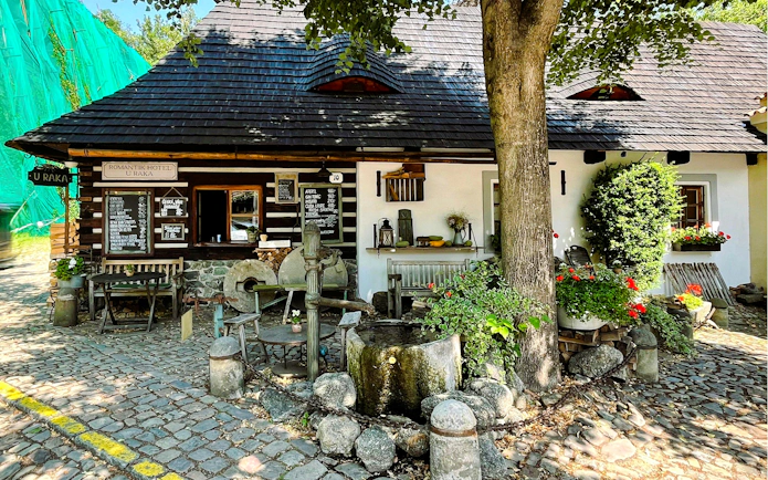 Romantik Hotel U Raka's rustic exterior with cobblestone path in Nový Svět, Prague.