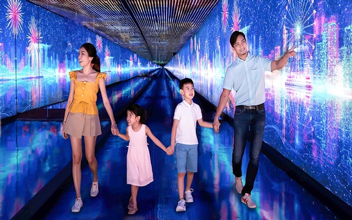 Family exploring digital art tunnel at Time Capsule, Singapore.