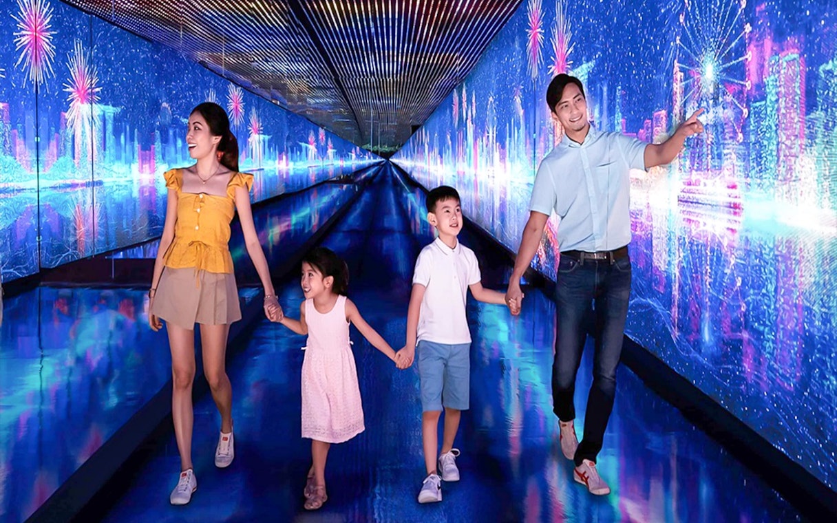 Family exploring digital art tunnel at Time Capsule, Singapore.