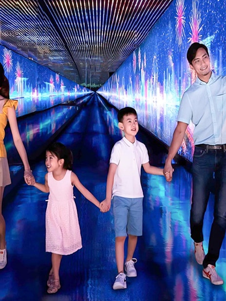 Family exploring digital art tunnel at Time Capsule, Singapore.