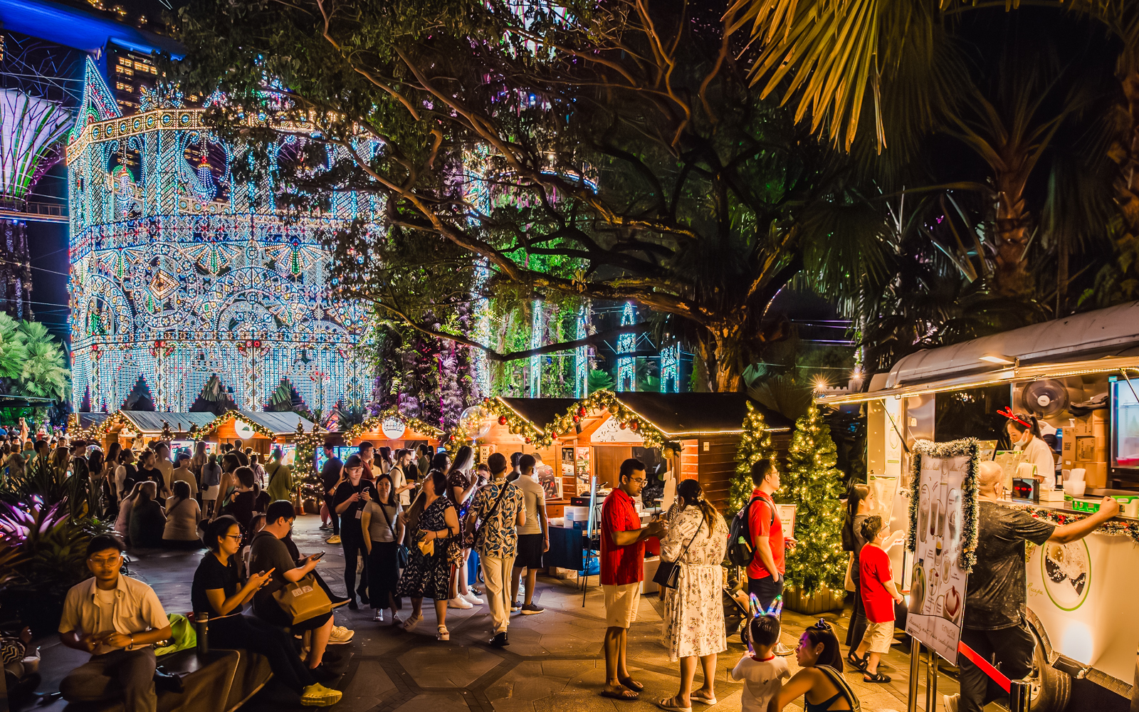 Festive huts and Christmas market at Gardens by the Bay, Singapore, with illuminated decorations.