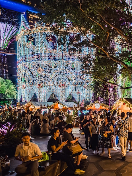Festive huts and Christmas market at Gardens by the Bay, Singapore, with illuminated decorations.