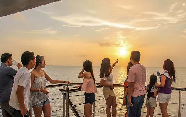 Group enjoying sunset on North Borneo Cruises in Kota Kinabalu.