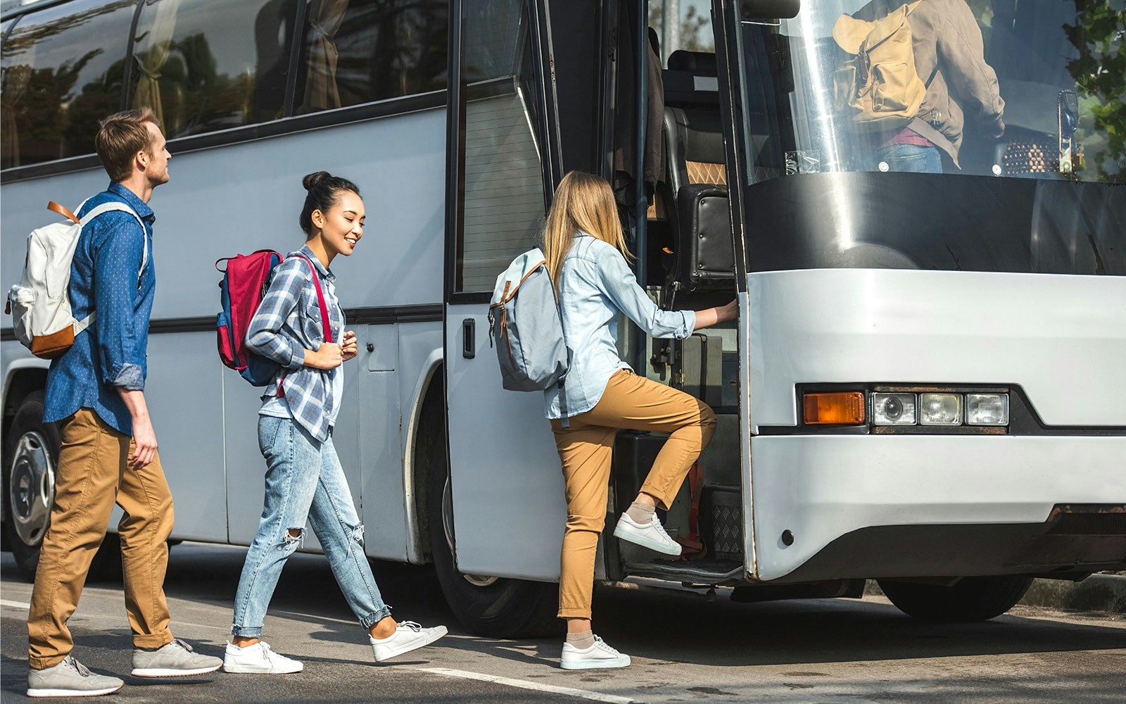 Travelers boarding a bus for shared transfer.