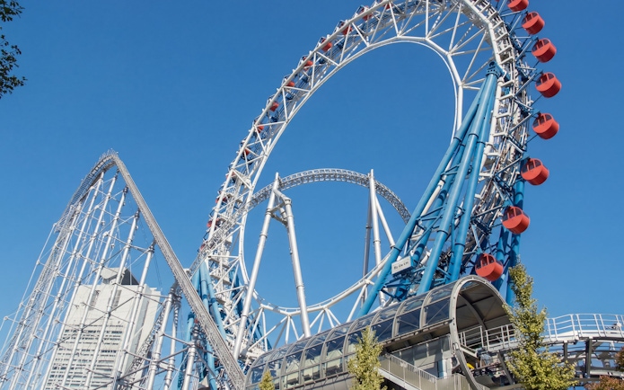 Roller coaster at Tokyo Dome City with blue sky background.