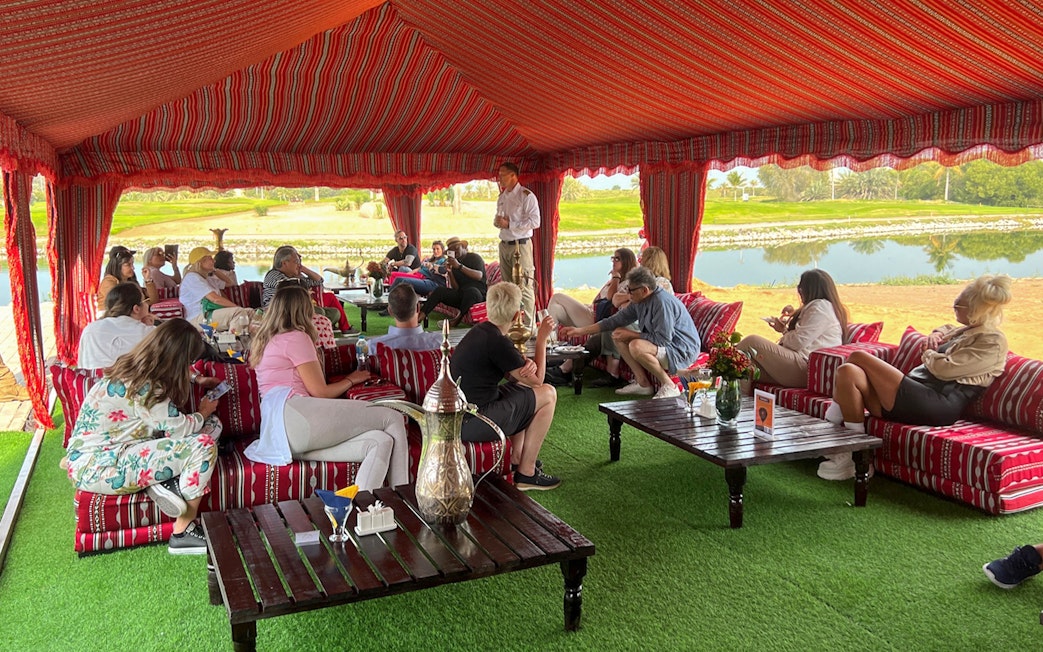 Guests seated in a traditional tent enjoying breakfast before a hot air balloon ride in Ras Al Khaimah.