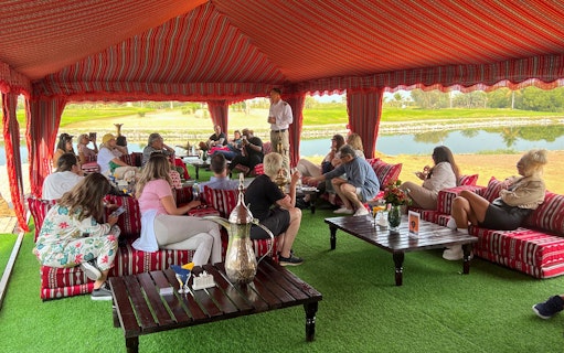 Guests seated in a traditional tent enjoying breakfast before a hot air balloon ride in Ras Al Khaimah.