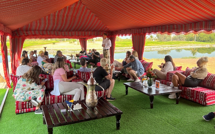 Guests seated in a traditional tent enjoying breakfast before a hot air balloon ride in Ras Al Khaimah.