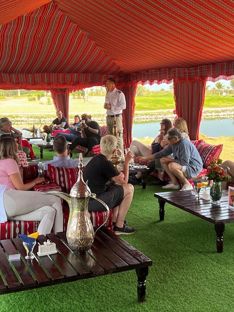 Guests seated in a traditional tent enjoying breakfast before a hot air balloon ride in Ras Al Khaimah.