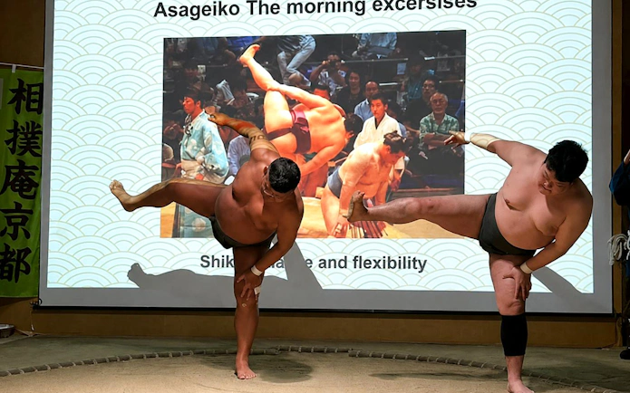 Sumo wrestlers demonstrating a pose during a Kyoto Sumo Show with Wrestler Challenge.
