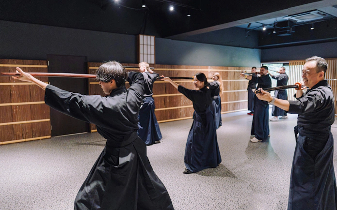 Participants practicing sword techniques at Samurai Museum Tokyo in Shinjuku.