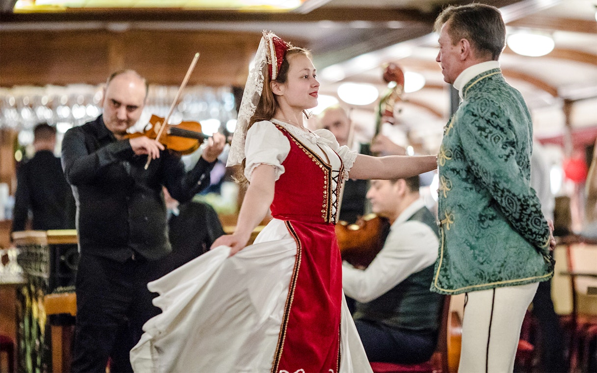 Rajk Folk Orchestra performing on a Danube dinner cruise at night.