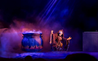 Disney villain performing near a cauldron at Mickey's Not-So-Scary Halloween Party, Orlando.