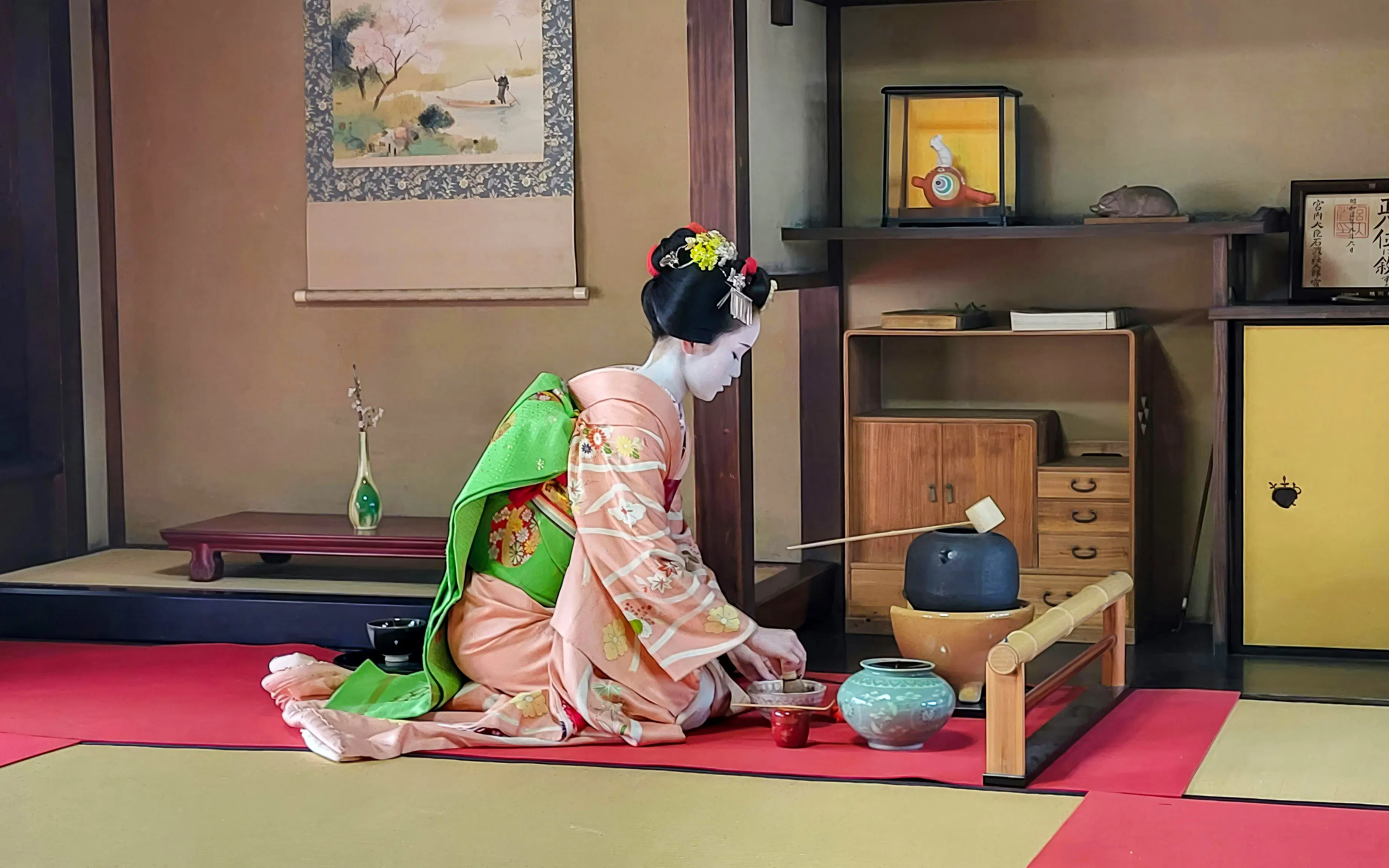 Geisha performing tea ceremony in traditional Kyoto room with Maiko.