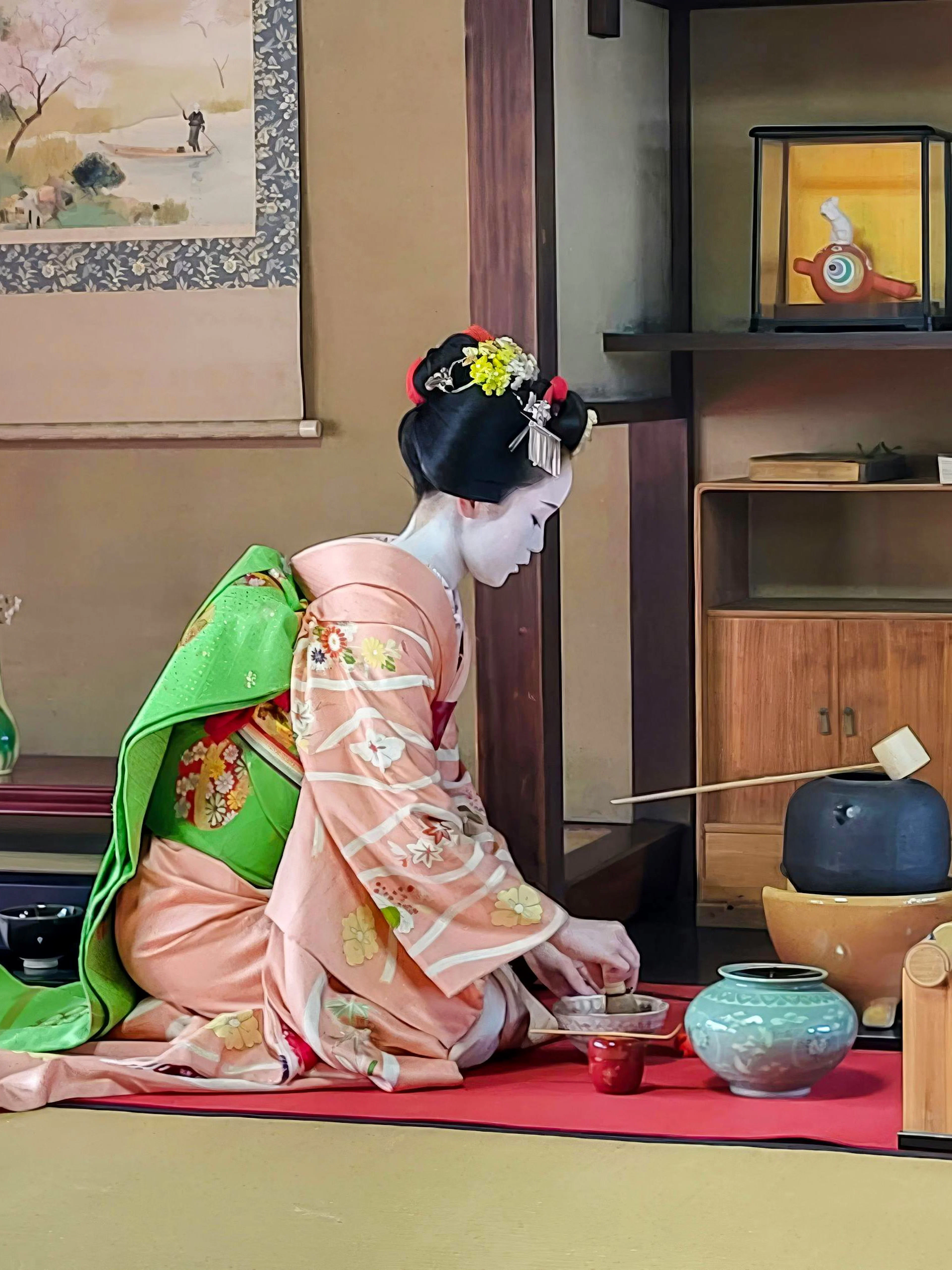 Geisha performing tea ceremony in traditional Kyoto room with Maiko.