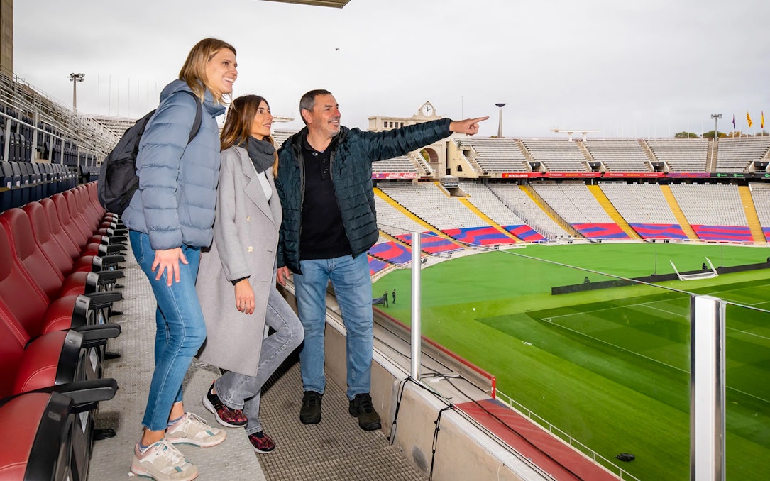 Visitors enjoying exclusive stadium access with a view of the pitch and seating at Barça Museum tour.