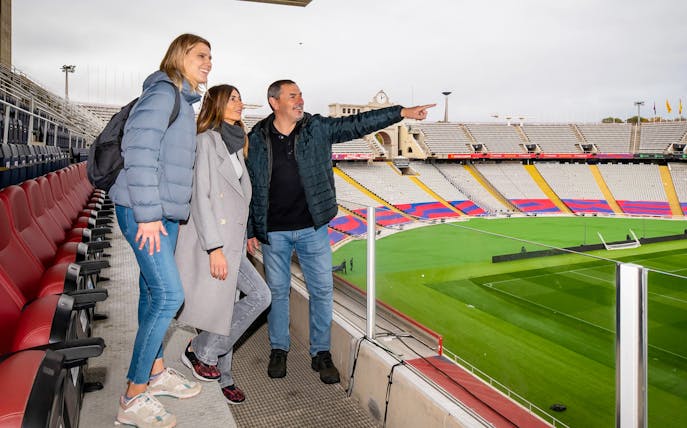 Visitors enjoying exclusive stadium access with a view of the pitch and seating at Barça Museum tour.