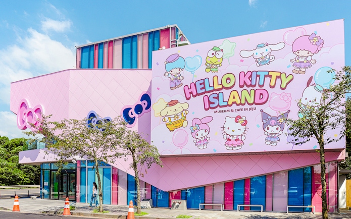 Exterior of Hello Kitty Island museum in Jeju with colorful character mural.