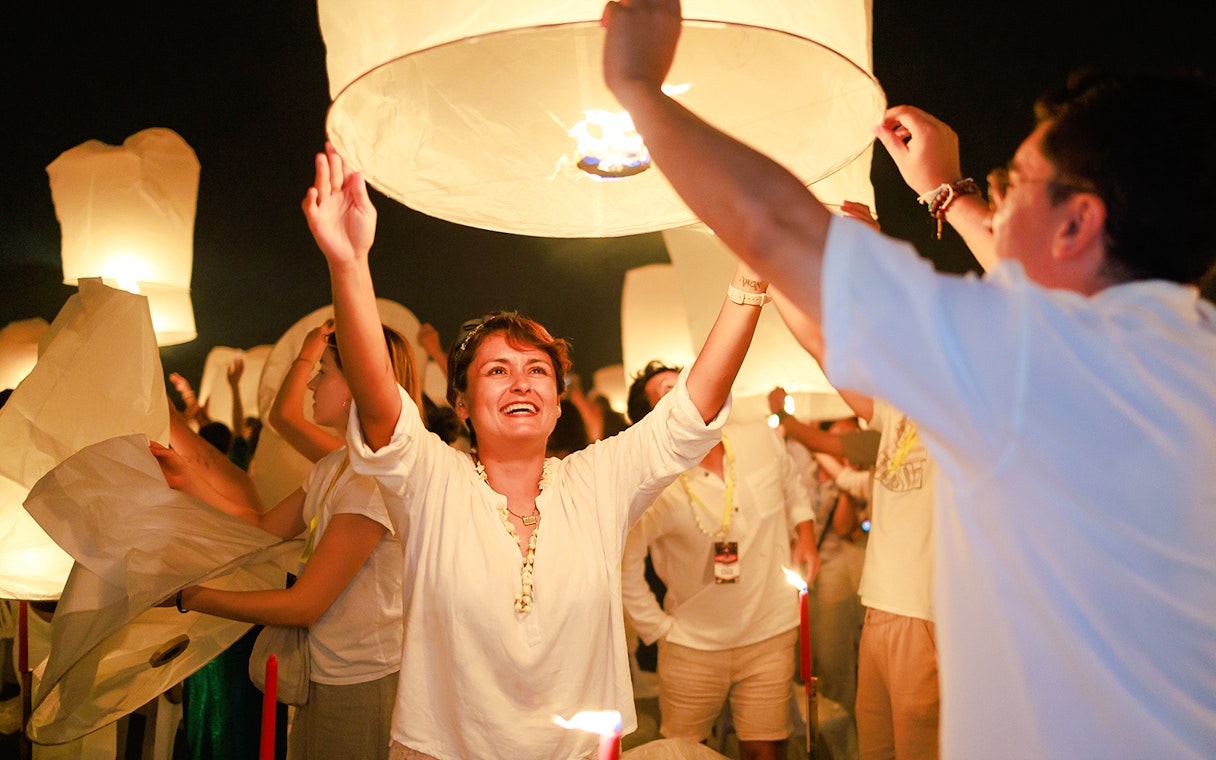 Couple releasing a sky lantern at Chiang Mai Sky Lanterns Festival.